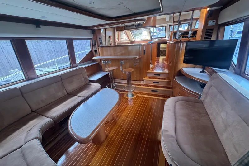 Slide: The Image of Luxurious interior of 2003 Custom Sea Star Pilot House with plush seating and wooden flooring. - 9
