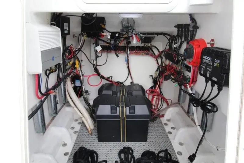 Slide: The Image of Electrical system inside a 1998 Contender 21 Open boat, featuring wiring and battery setup. - 7