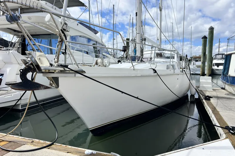 The Image of 1986 Amel Mango sailboat docked at marina, featuring sleek white hull and rigging. - 0