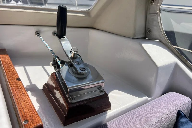 Slide: The Image of Throttle control lever on 1986 Amel Mango sailboat, featuring wooden and metal components. - 12