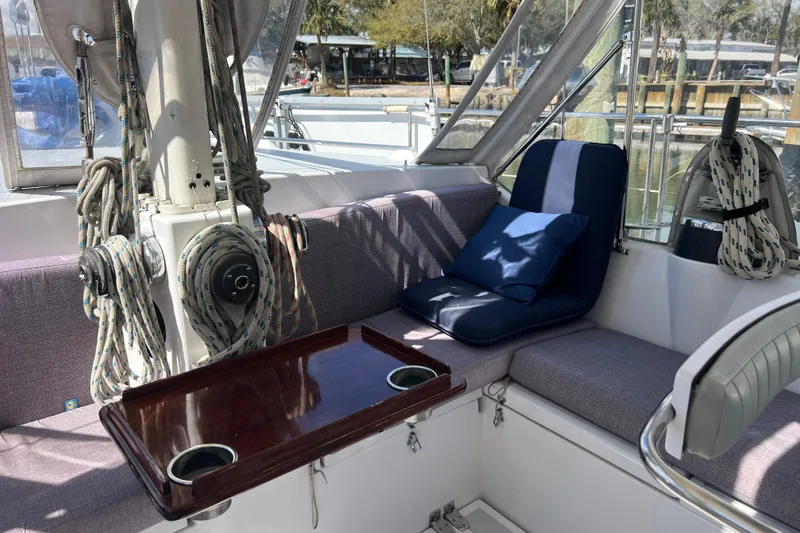 Slide: The Image of Cozy seating area on 1986 Amel Mango sailboat with cushions and ropes. - 13