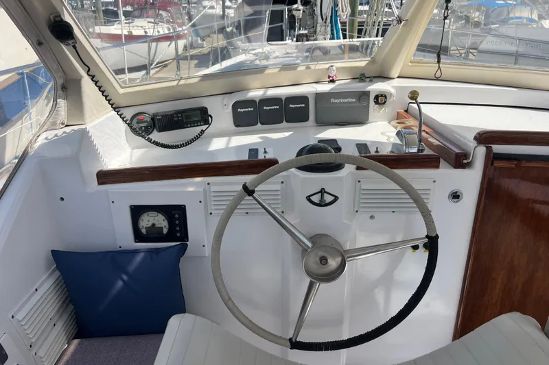 Slide: The Image of Cockpit of 1986 Amel Mango sailboat with steering wheel and navigation equipment. - 14