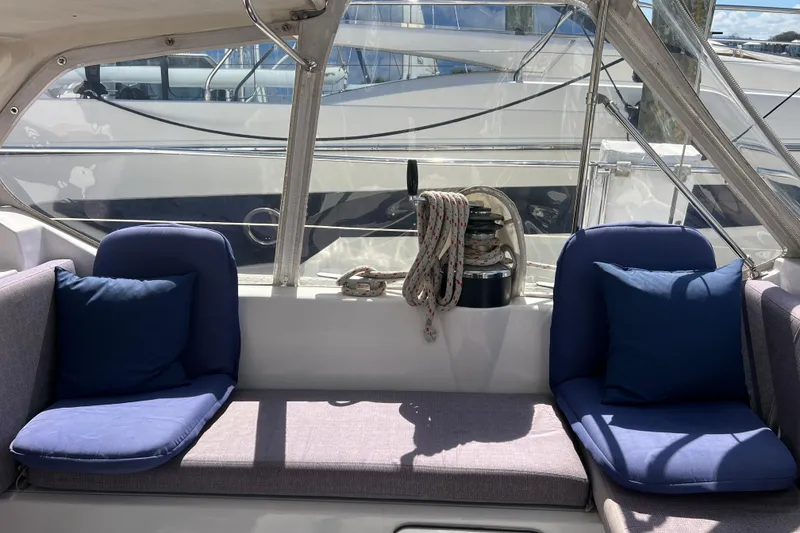 Slide: The Image of Cozy seating area on 1986 Amel Mango yacht with blue cushions and nautical ropes. - 18