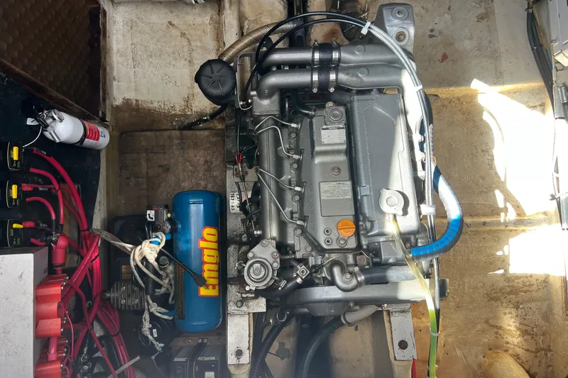 Slide: The Image of Engine compartment of a 1986 Amel Mango sailboat with visible components and wiring. - 23