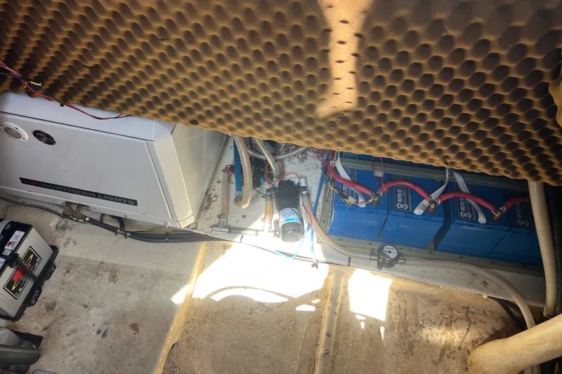 Slide: The Image of Engine room of 1986 Amel Mango sailboat with batteries and generator. - 24