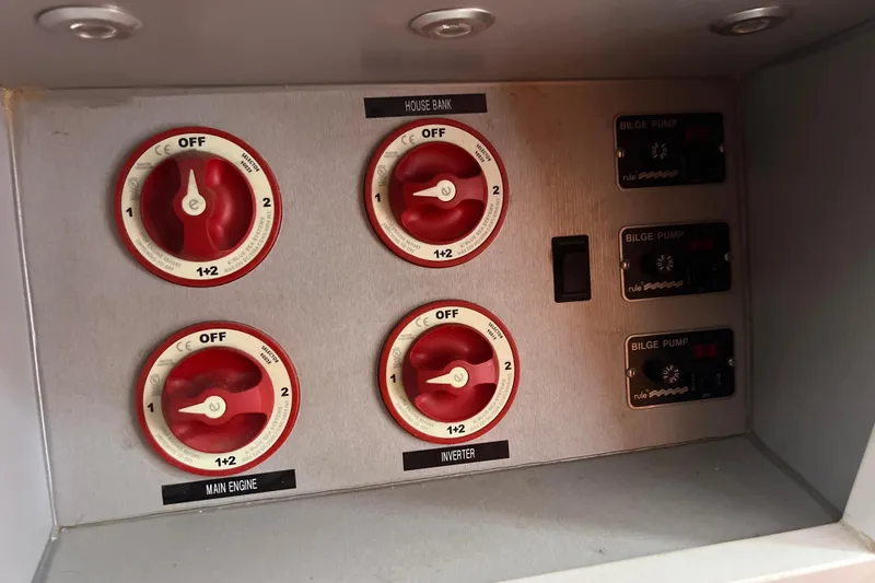 Slide: The Image of Electrical control panel with switches and bilge pump controls on a 1986 Amel Mango boat. - 33