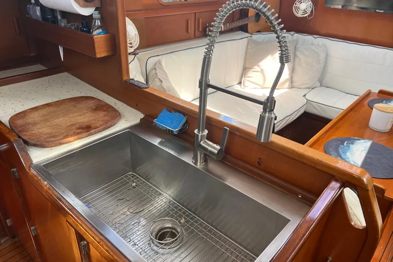 Slide: The Image of Galley of 1986 Amel Mango yacht with stainless steel sink and cozy seating area. - 39