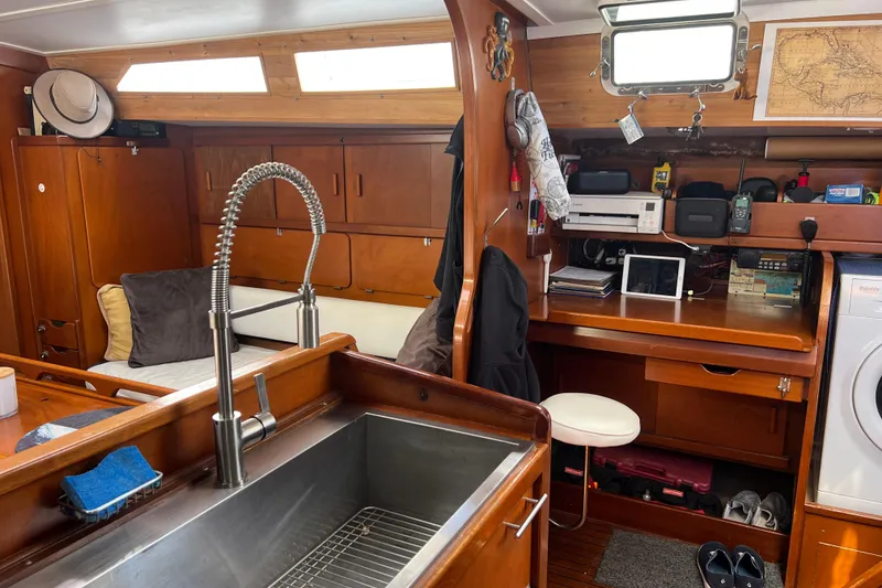 Slide: The Image of Interior of 1986 Amel Mango sailboat with wooden cabinetry and modern amenities. - 42