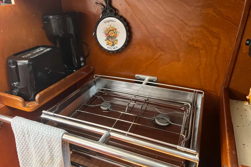 Slide: The Image of Compact kitchen in 1986 Amel Mango boat with stove, toaster, and coffee maker. - 43