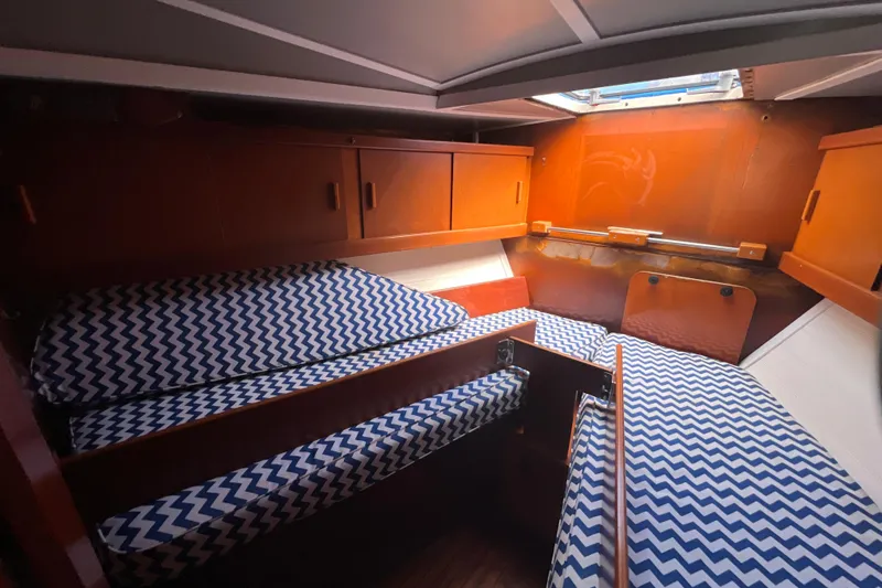 Slide: The Image of Cozy cabin interior of 1986 Amel Mango sailboat with zigzag patterned cushions. - 45