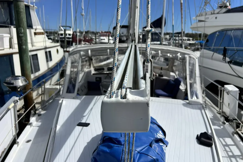 Slide: The Image of Sailboat deck view of 1986 Amel Mango in marina, surrounded by other boats. - 53