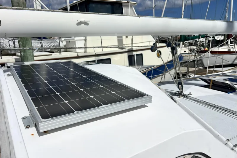 Slide: The Image of Solar panel on 1986 Amel Mango sailboat deck at marina. - 57