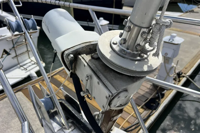 Slide: The Image of Close-up of a 1986 Amel Mango sailboat's rigging and winch system at a marina. - 60