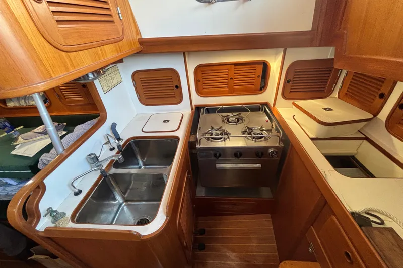 Slide: The Image of Metal fitting on Mason 33 sailboat, 1985, with black rope through it. - 12