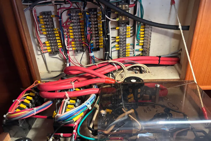 Slide: The Image of Electrical wiring and fuse panel inside a 1985 Mason 33 boat. - 28