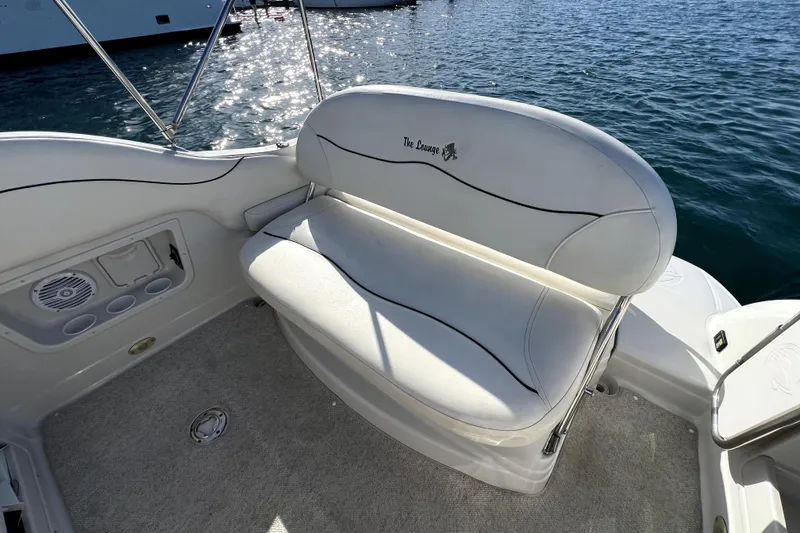 Slide: The Image of White seating area on 2004 Crownline 250 CR boat, overlooking water. - 11