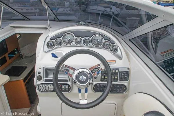 Slide: The Image of 2004 Crownline 250 CR boat dashboard with steering wheel and control panel. - 29