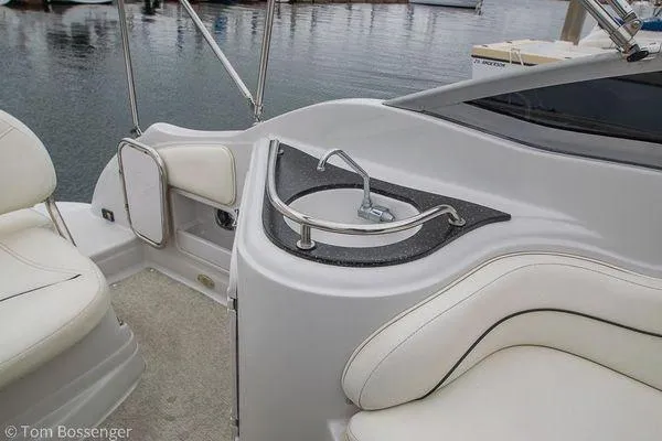 Slide: The Image of 2004 Crownline 250 CR boat interior with sink and seating area. - 31
