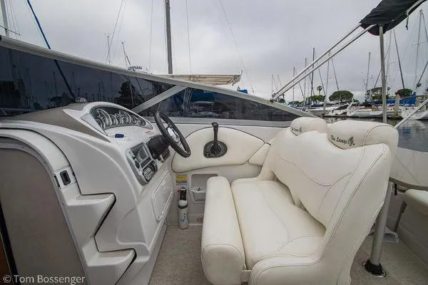 Slide: The Image of 2004 Crownline 250 CR boat interior with white seating and control panel. - 33