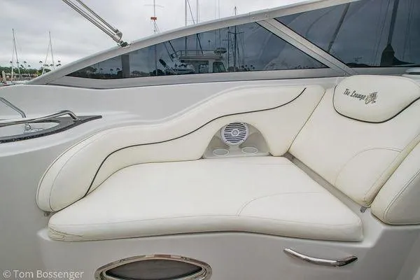 Slide: The Image of 2004 Crownline 250 CR boat interior with white cushioned seating and speaker. - 37