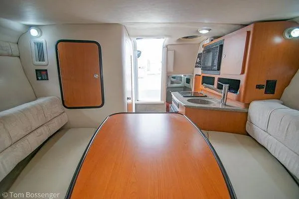 Slide: The Image of 2004 Crownline 250 CR cabin interior with kitchenette and seating area. - 42