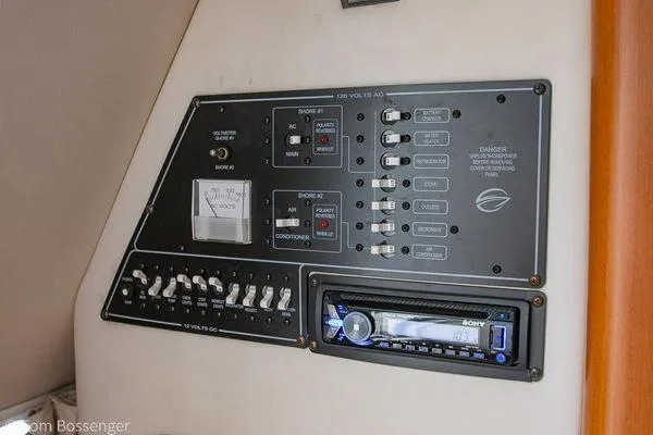 Slide: The Image of Control panel of a 2004 Crownline 250 CR boat with switches and a Sony stereo. - 48