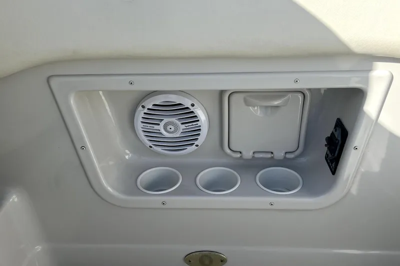 Slide: The Image of 2004 Crownline 250 CR boat interior with speaker and cup holders. - 49
