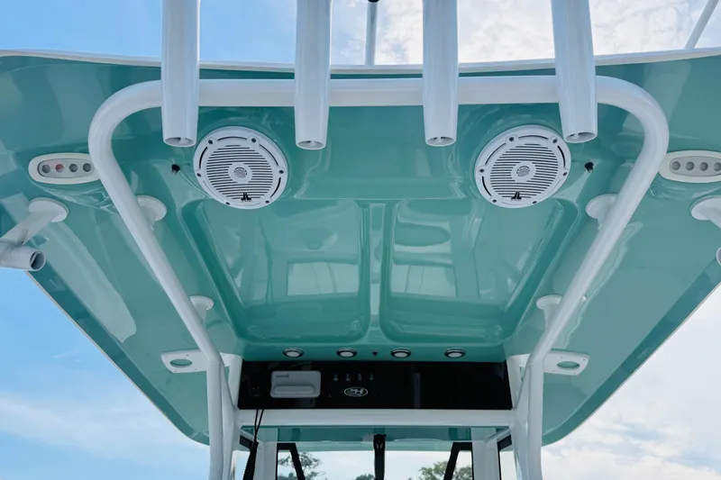 Slide: The Image of 2023 Sea Hunt Ultra 255 SE boat roof with speakers and rod holders. - 12