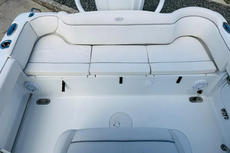 Slide: The Image of 2023 Sea Hunt Ultra 255 SE boat interior with white cushioned seating. - 13