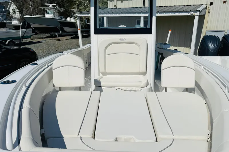 Slide: The Image of 2023 Sea Hunt Ultra 255 SE boat interior with white seating and console. - 16