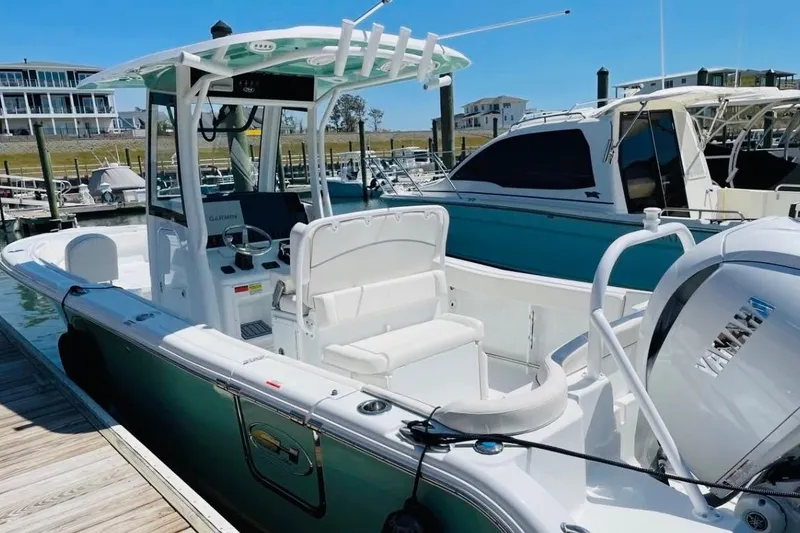 Slide: The Image of 2023 Sea Hunt Ultra 255 SE boat docked, featuring Yamaha engine and modern design. - 18