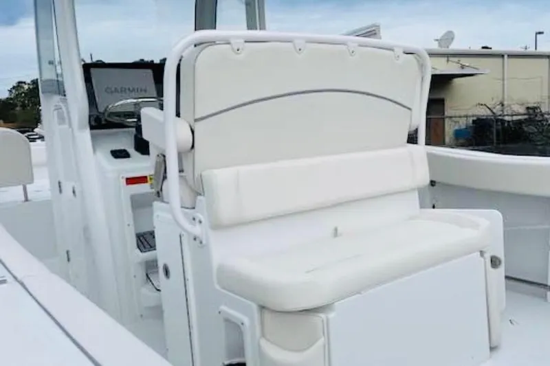 Slide: The Image of 2023 Sea Hunt Ultra 255 SE boat interior with white seating and Garmin equipment. - 20