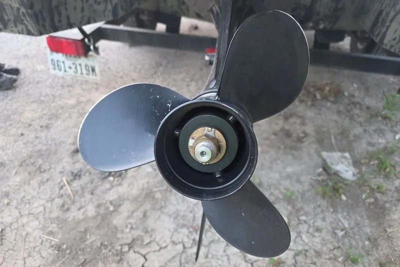 Slide: The Image of 2025 Tracker Grizzly 1860 MVX CC boat with Lowrance fish finder and camo interior. - 16