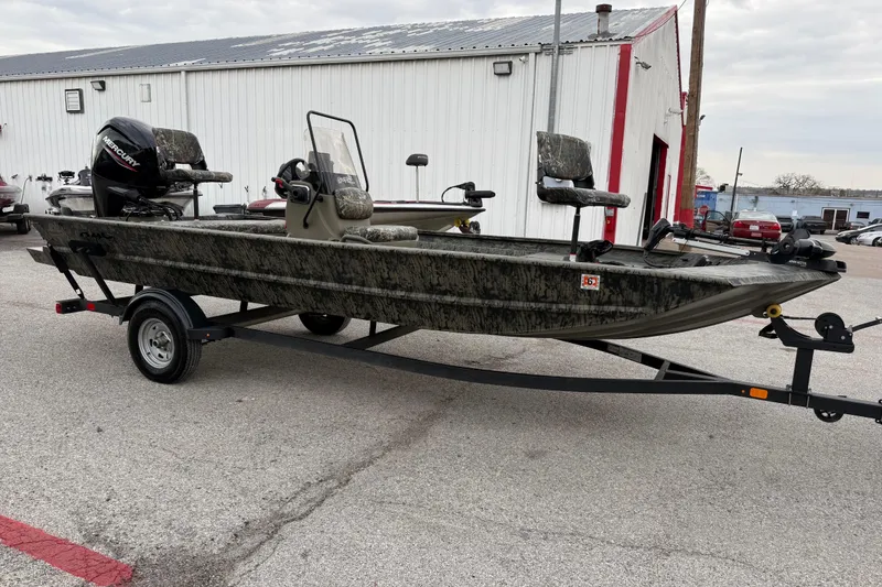 Slide: The Image of 2025 Tracker Grizzly 1860 MVX CC boat interior with camouflage seating and storage. - 19