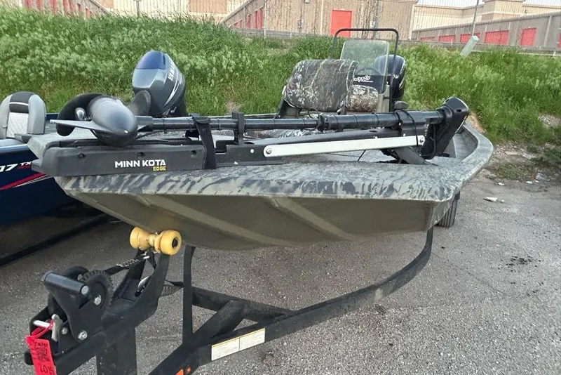 Slide: The Image of 2025 Tracker Grizzly 1860 MVX CC boat on trailer at Cransh Auto Sales. - 2