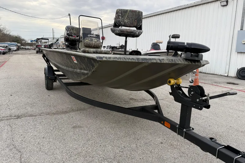 Slide: The Image of 2025 Tracker Grizzly 1860 MVX CC boat with camo design and Mercury engine. - 22