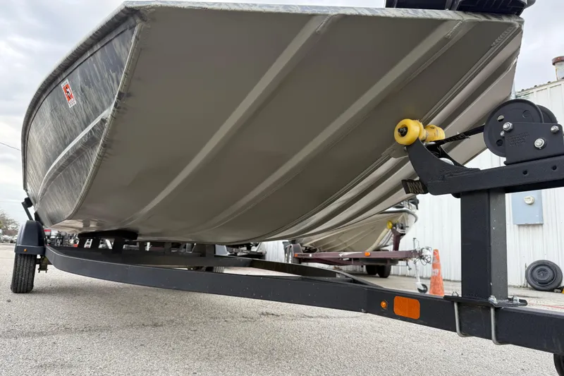 Slide: The Image of 2025 Tracker Grizzly 1860 MVX CC boat with camo pattern and VersaTrack label. - 23