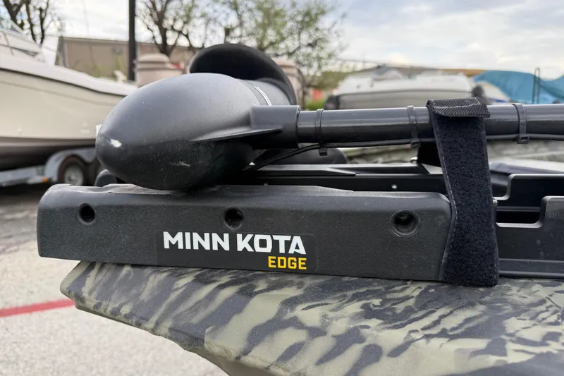 Slide: The Image of 2025 Tracker Grizzly 1860 MVX CC with Mercury 90 engine in a boatyard. - 26