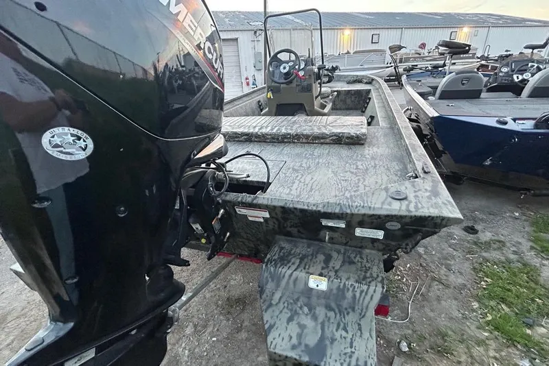 Slide: The Image of 2025 Tracker Grizzly 1860 MVX CC boat with camouflage design on trailer. - 3