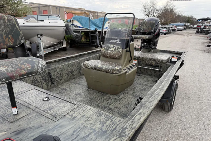 Slide: The Image of 2025 Tracker Grizzly 1860 MVX CC boat battery compartment with wiring and components. - 30