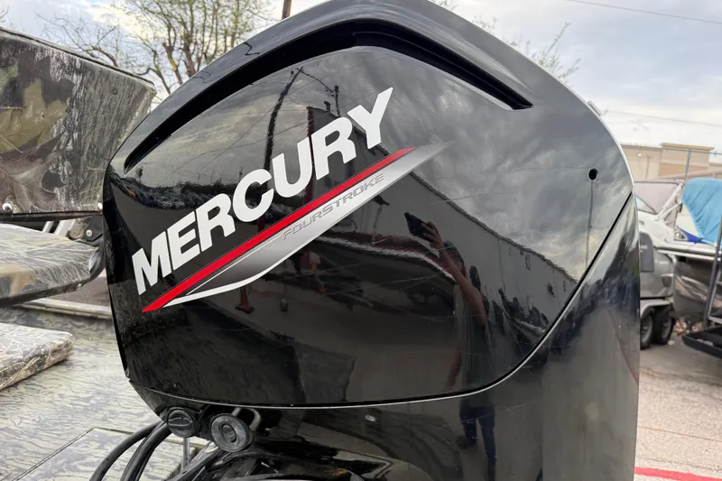 Slide: The Image of Storage compartment of 2025 Tracker Grizzly 1860 MVX CC with battery and charger. - 36