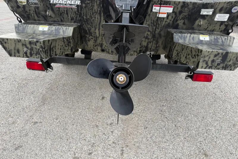 Slide: The Image of 2025 Tracker Grizzly 1860 MVX CC interior with camouflage pattern and seating. - 38