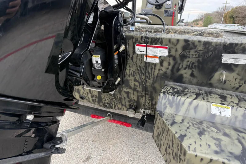 Slide: The Image of 2025 Tracker Grizzly 1860 MVX CC boat interior with steering console and gauges. - 39