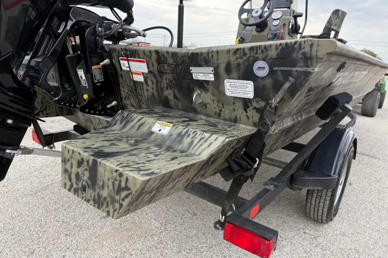 Slide: The Image of 2025 Tracker Grizzly 1860 MVX CC boat with camouflage design on a trailer. - 40