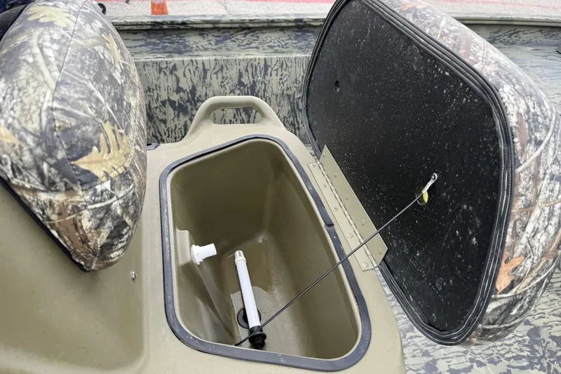 Slide: The Image of 2025 Tracker Grizzly 1860 MVX CC boat on trailer, camo design, outdoor sales location. - 44