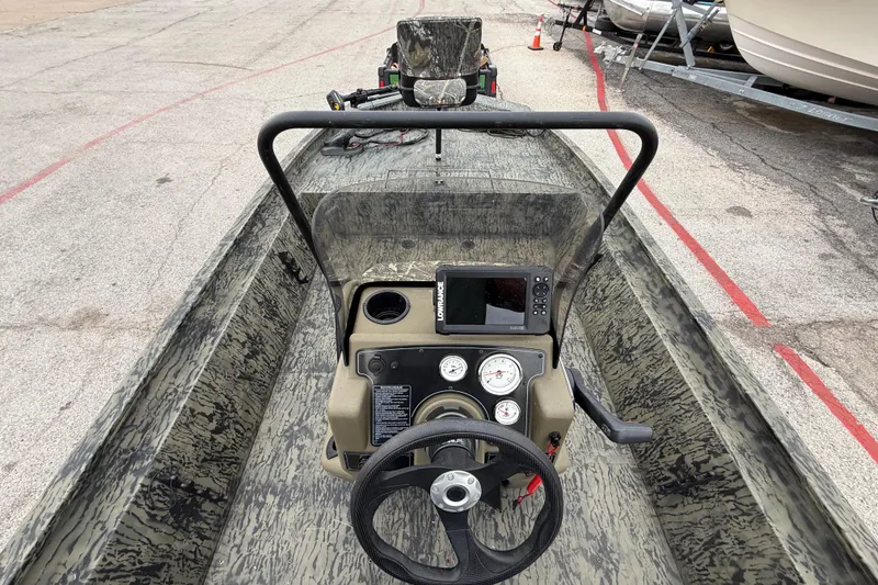 Slide: The Image of 2025 Tracker Grizzly 1860 MVX CC boat with Mercury engine on trailer. - 50