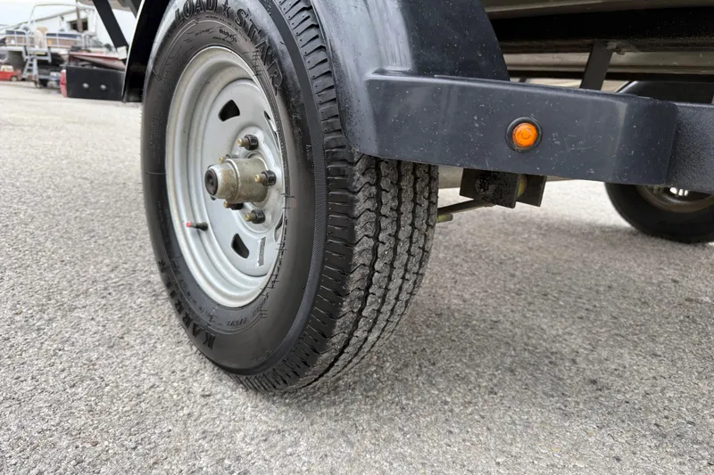 Slide: The Image of 2025 Tracker Grizzly 1860 MVX CC boat on trailer by waterfront. - 53