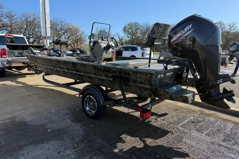 Slide: The Image of 2025 Tracker Grizzly 1860 MVX CC boat on trailer with Mercury outboard motor. - 57