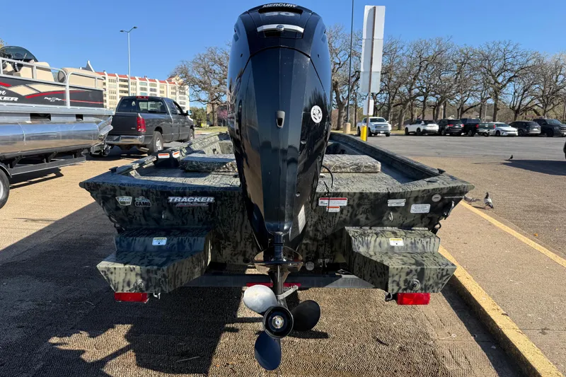 Slide: The Image of 2025 Tracker Grizzly 1860 MVX CC boat with camo design and powerful outboard motor. - 58