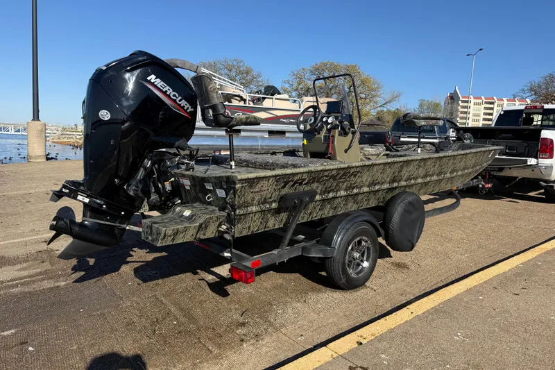 Slide: The Image of 2025 Tracker Grizzly 1860 MVX CC boat on trailer with Mercury outboard motor. - 59